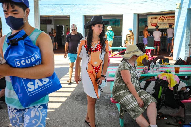 A woman wears a novelty t-shirt with a bikini body painted on it at the concession area of the Rockaways